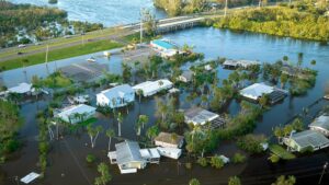 Aerial view of flooded houses next to a river